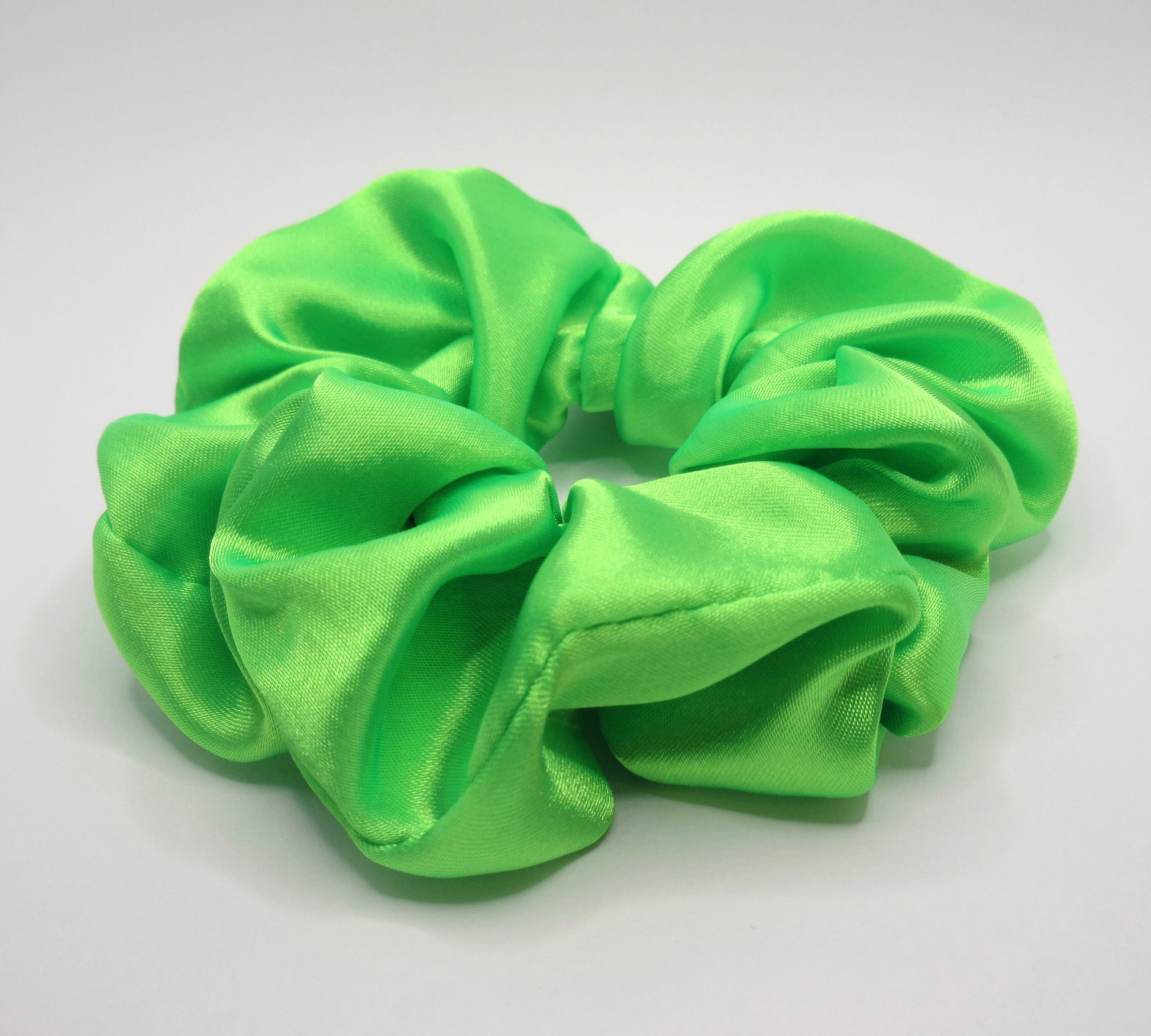 Green scrunchie on a white background