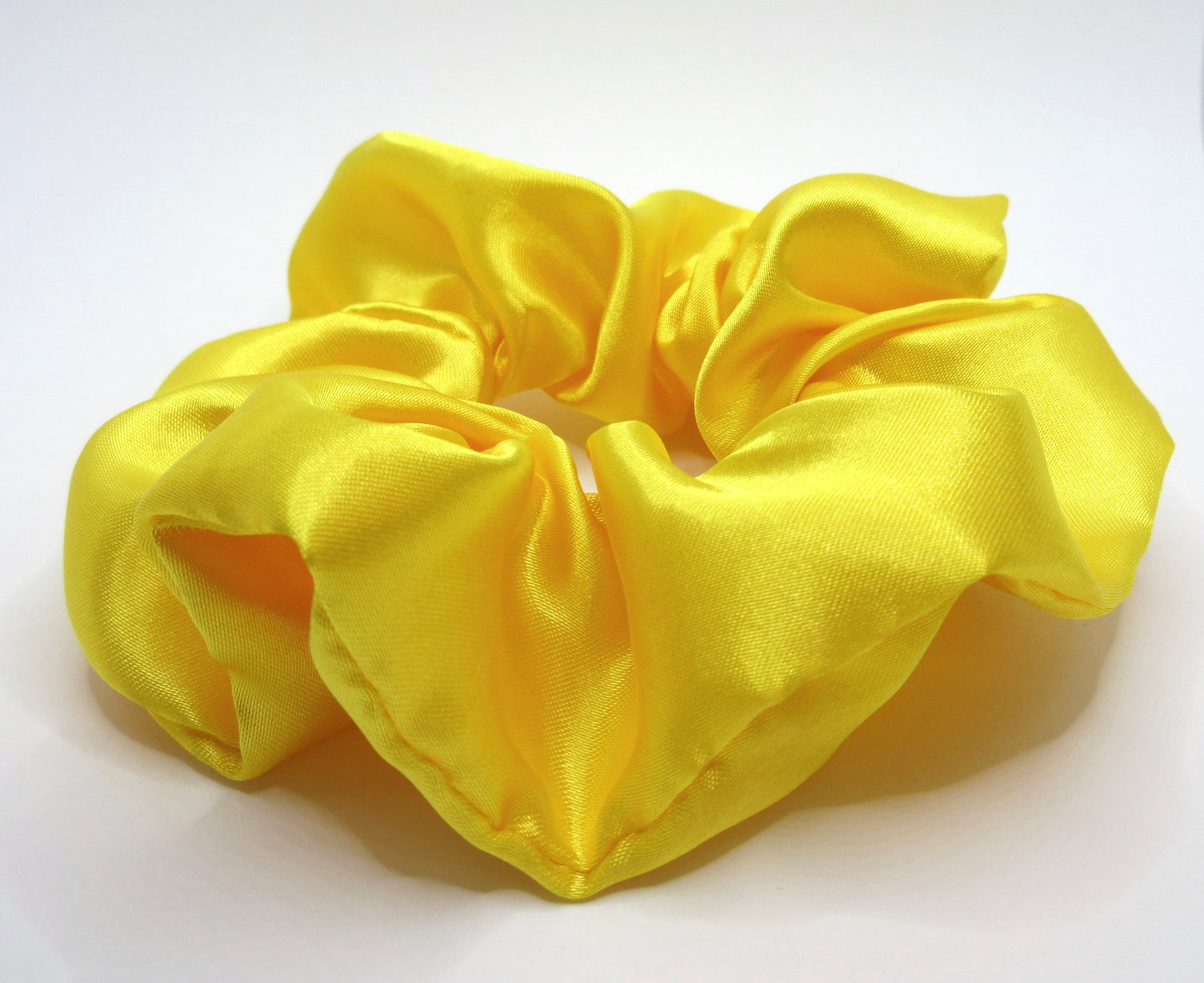 Yellow scrunchie on a white background